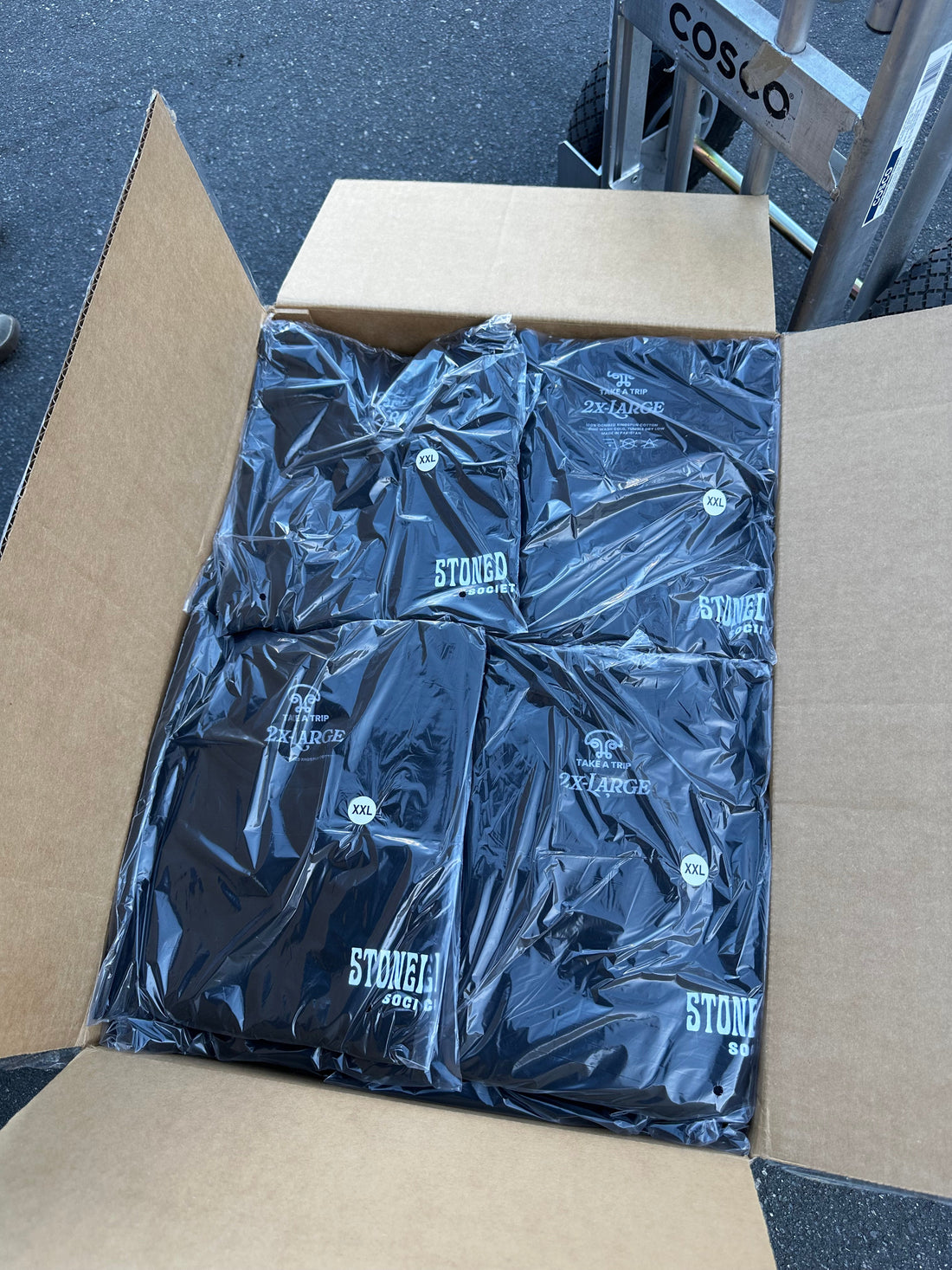 Box of individually folded and packaged custom apparel prepared for retail fulfillment
