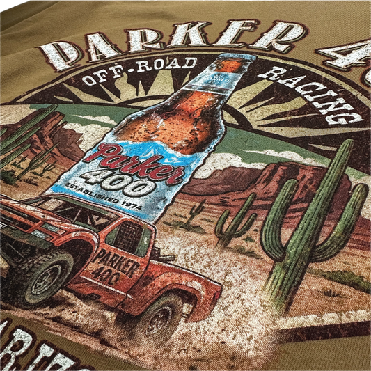 Close-up of a detailed multicolor screen print showing ink texture on a brown T-shirt