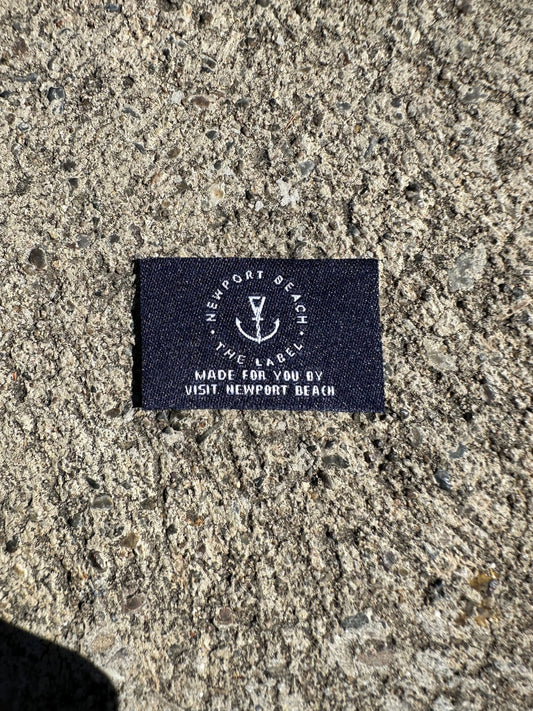 Printed athletic neck label and woven clothing label examples used in custom apparel finishing